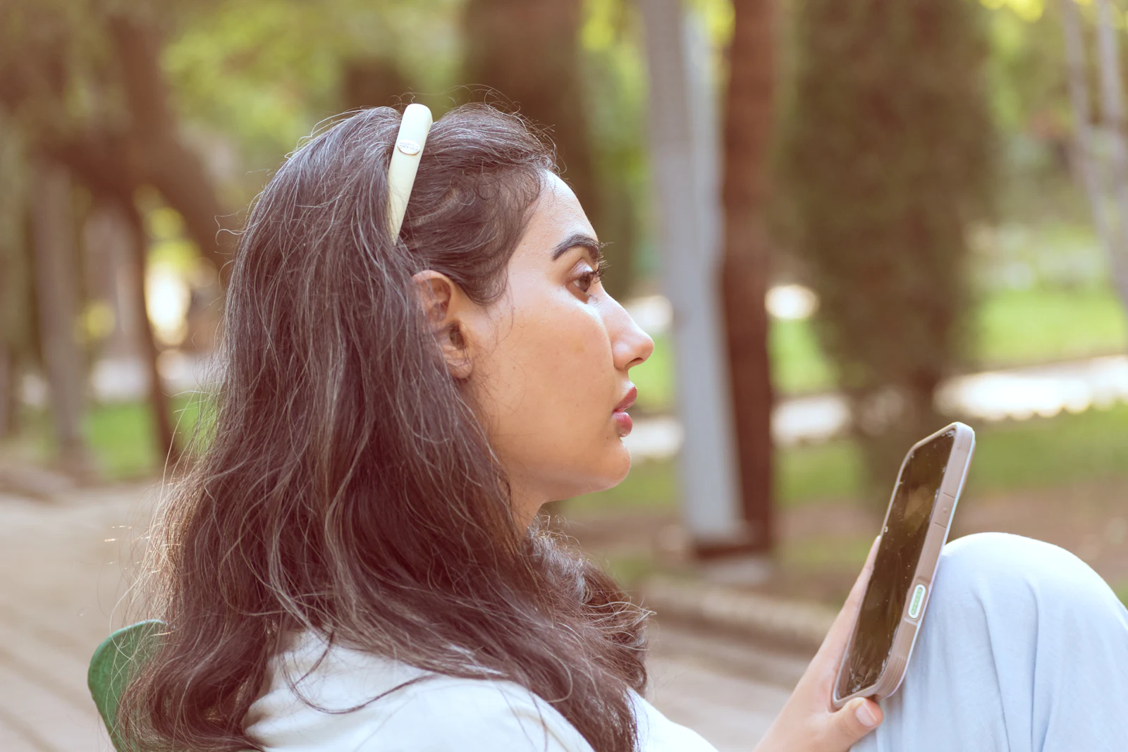 A woman using a wellbeing app on her phone outdoors